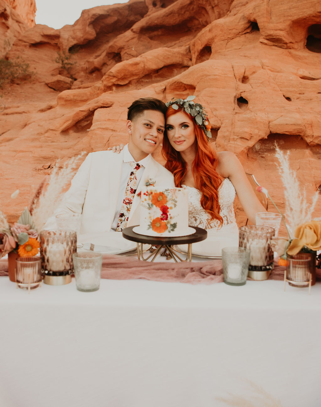 Couple sitting at Whimsical sweetheart table 