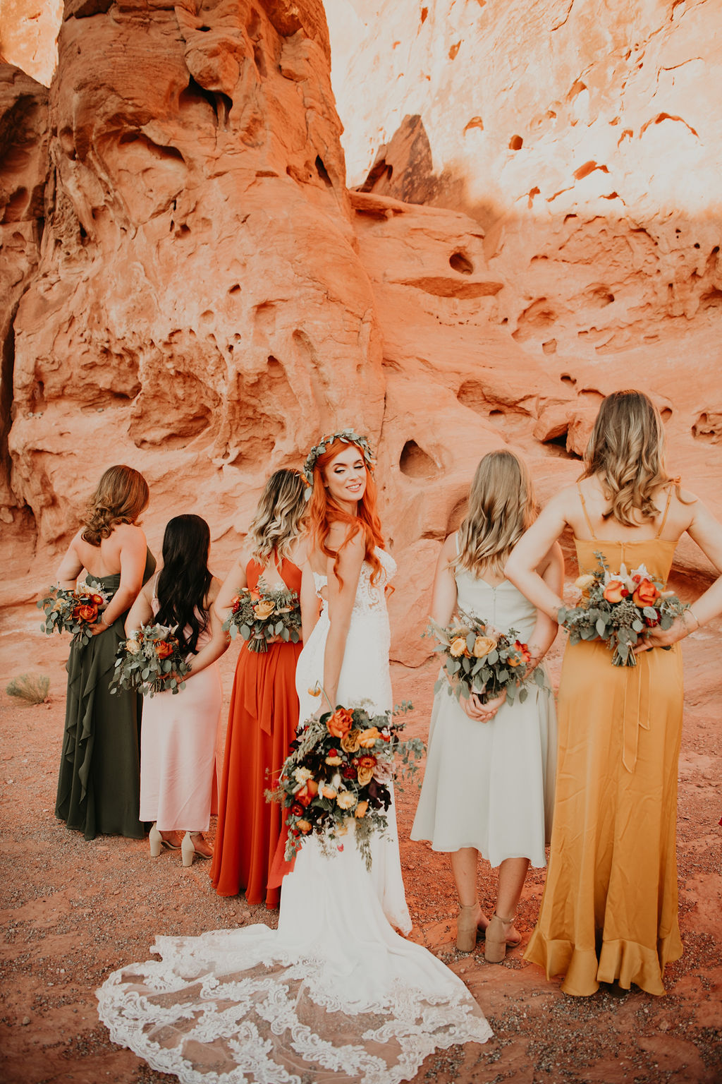 Wedding party holding boho bouquets behind their back 