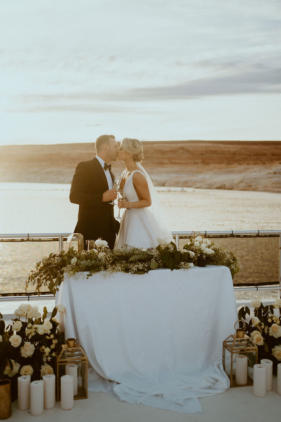 Couple Kissing at Sweetheart Table for Lake Powell Elopement 