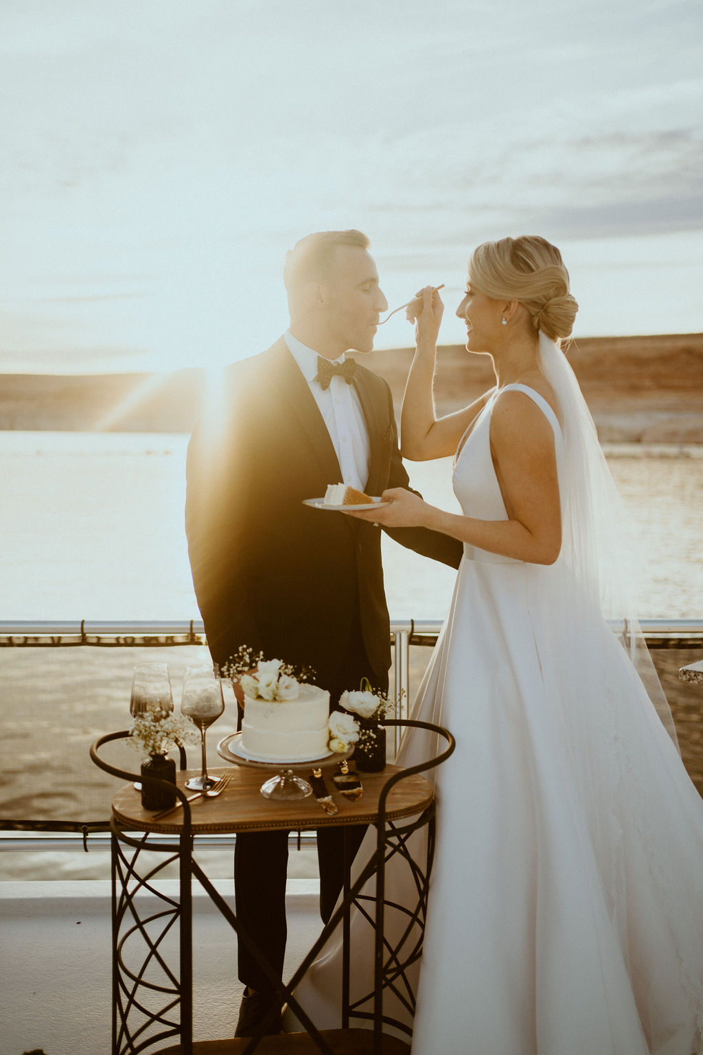 Sunset Photos of Couple Cutting the Cake for Elopement on Lake Powell 