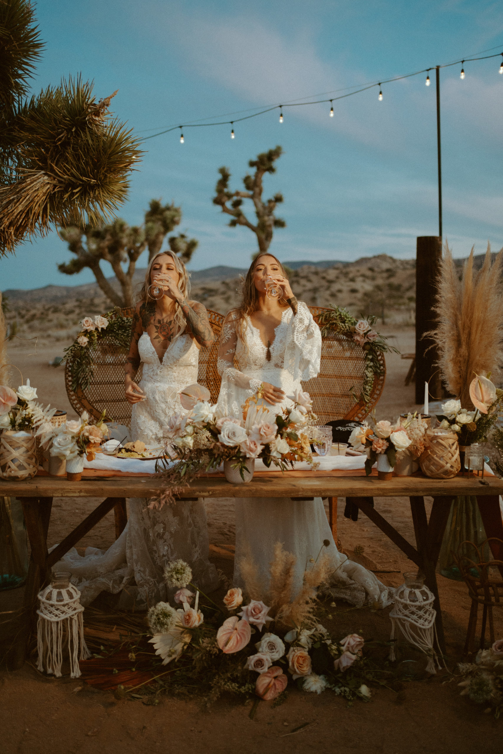 Couple drinking champagne at boho sweetheart table in Joshua Tree 