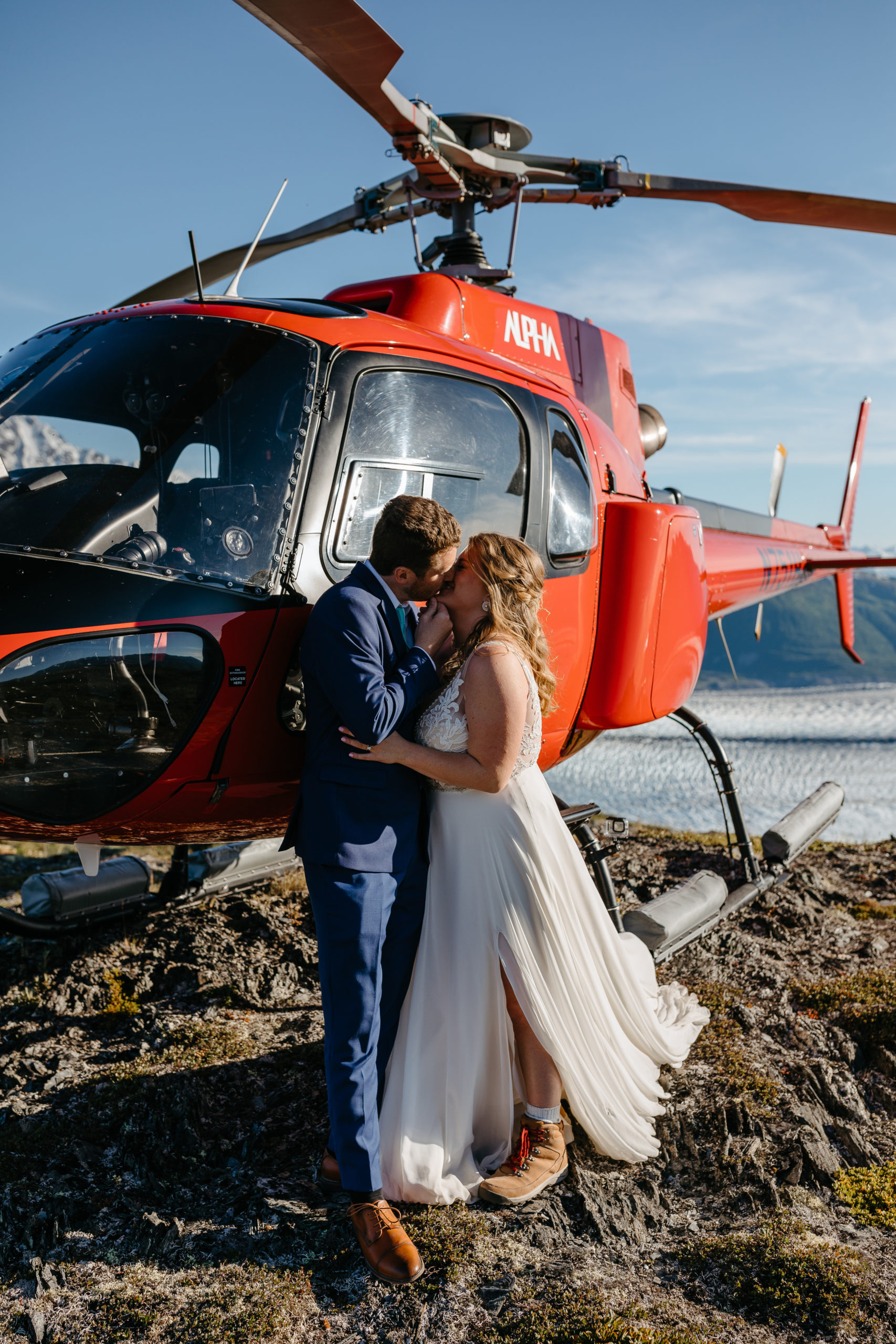 Couple Kissing near Helicopter after Alaskan Ceremony 