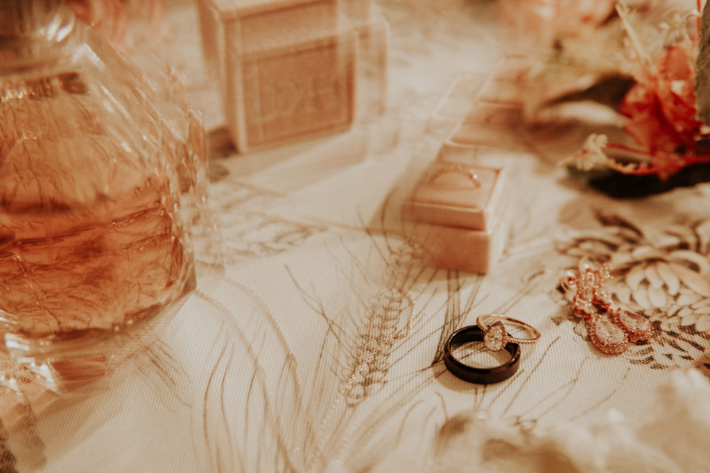 perfume, wedding rings, flowers and ring box