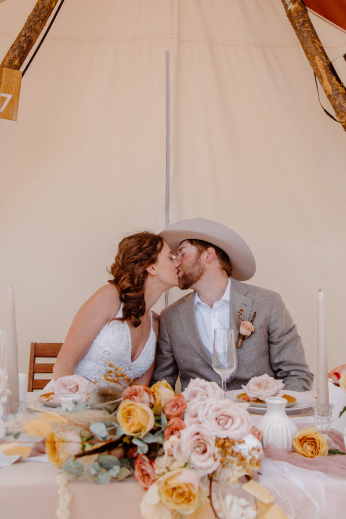 Couple Kissing at Sweetheart Table 