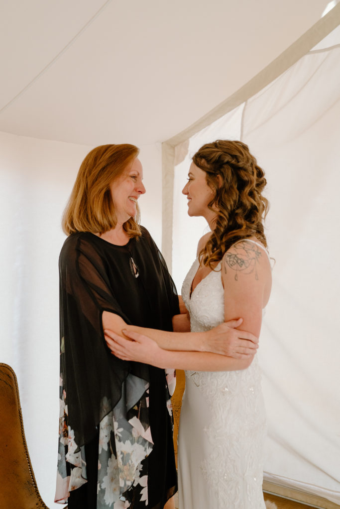 Bride and Mother having a moment while getting ready 