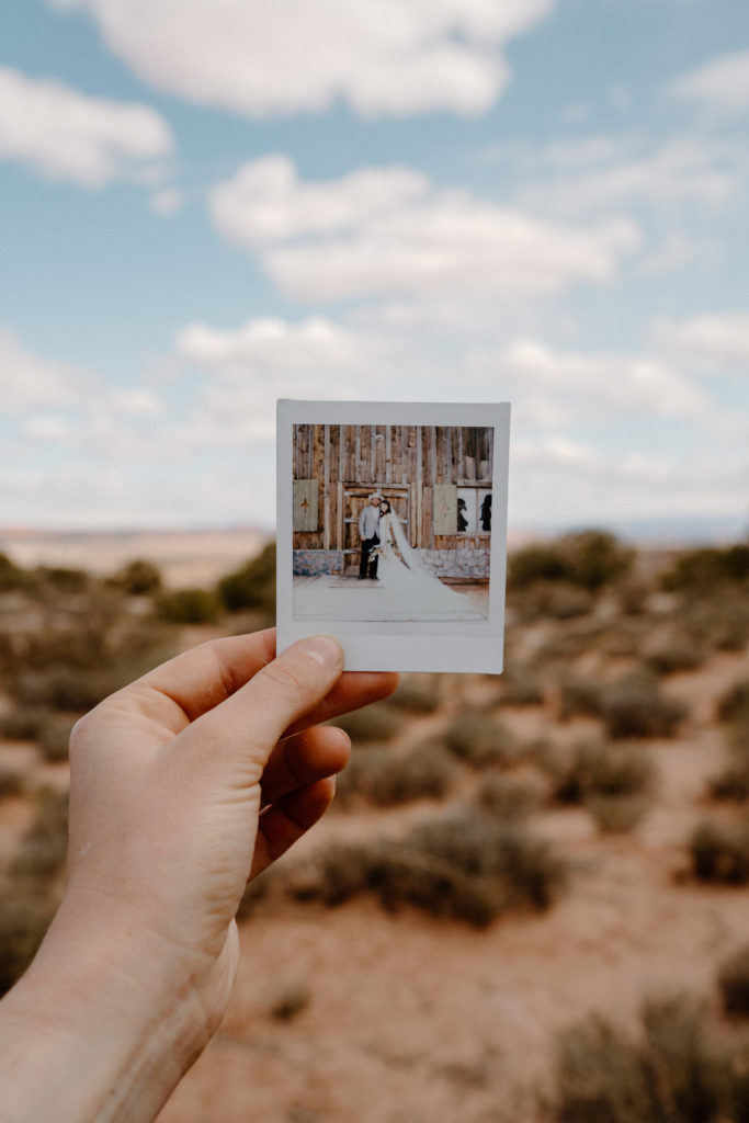 Polaroid Picture of Newlyweds held up against Canyonlands National Park