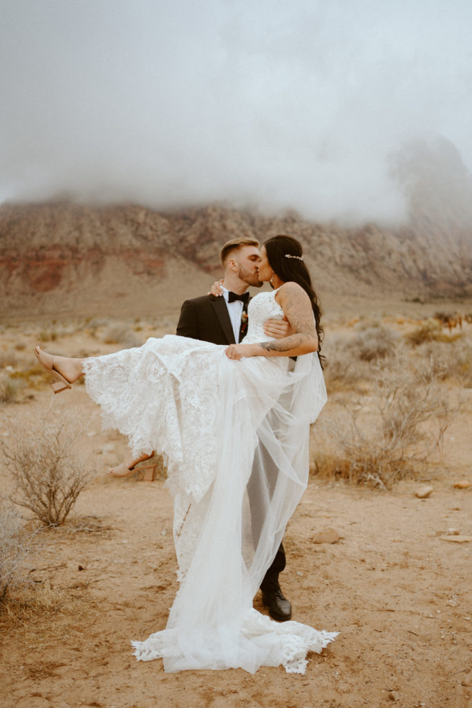 Groom holding bride and kissing her for Red Rock Bridals & Simple Affair Micro-Wedding 