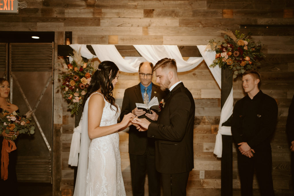 Bride and Groom exchanging rings during wedding ceremony 