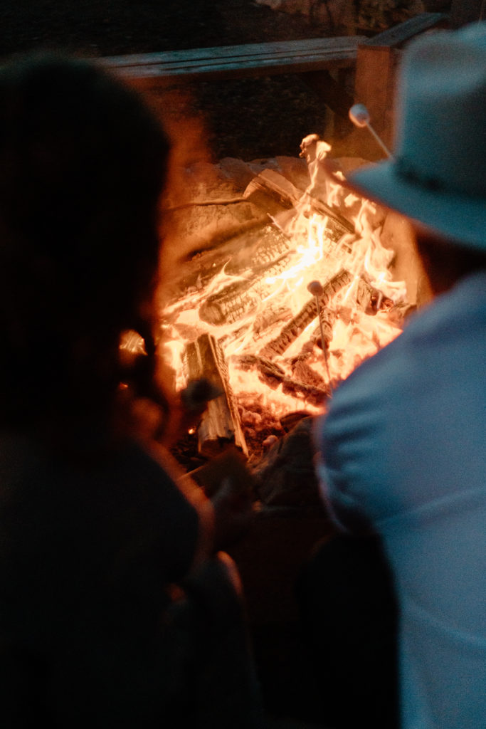 Roasting Marshmallows in Camp Fire after elopement ceremony 