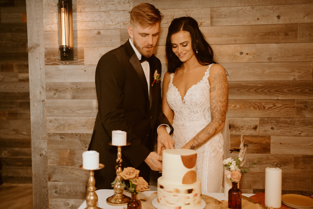 Couple cutting cake during reception 