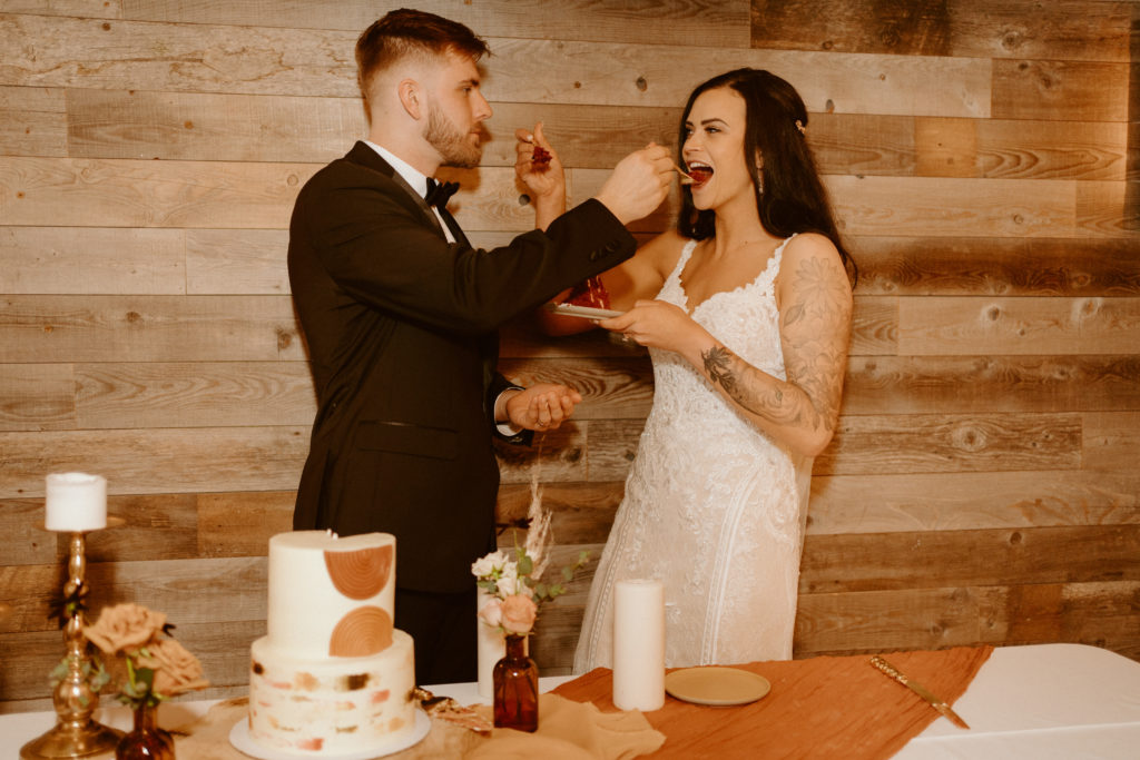 Newlyweds feeling each other cake for reception 