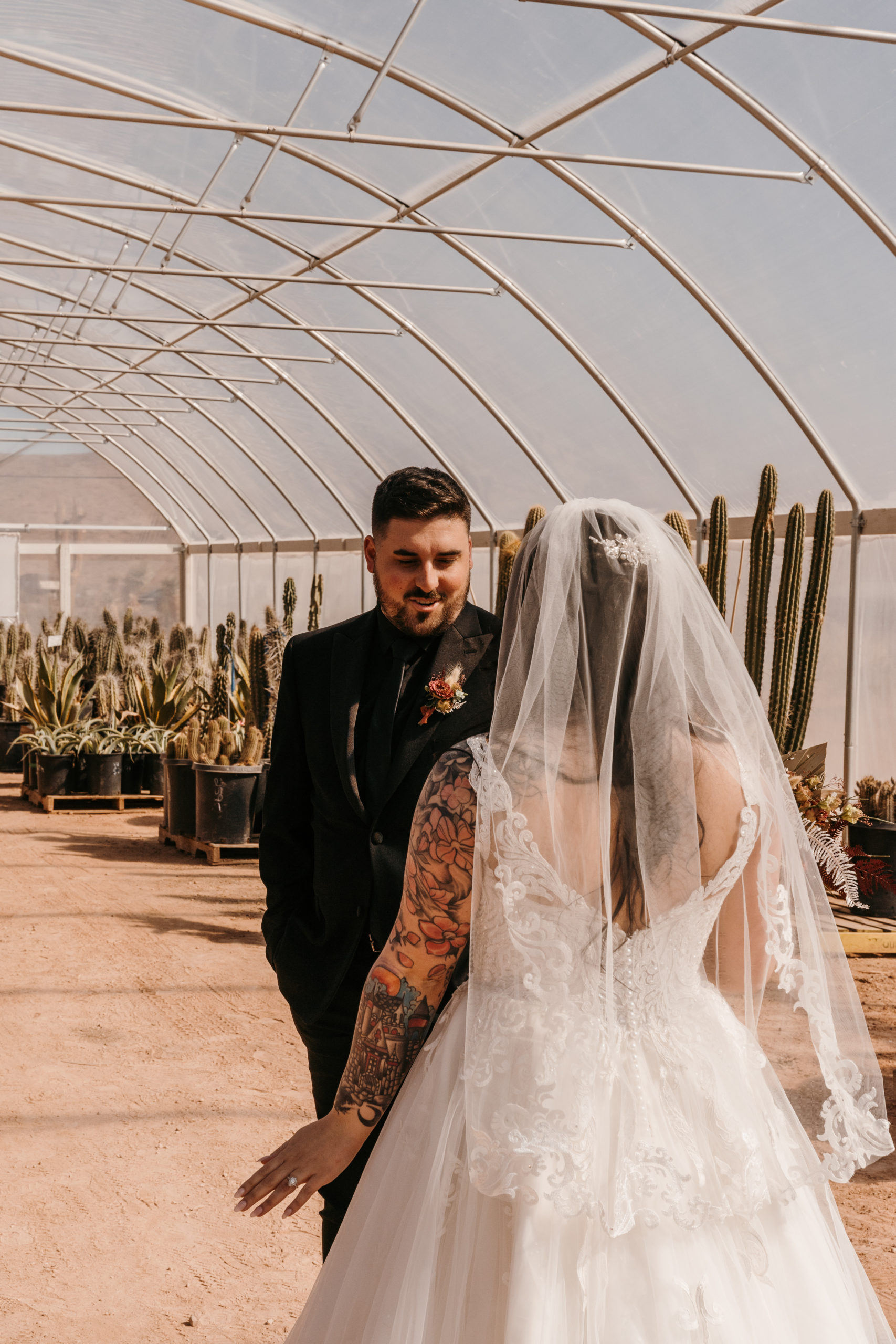 Groom's reaction to seeing his bride for the first time in cactus greenhouse during Modern-Boho Las Vegas Elopement