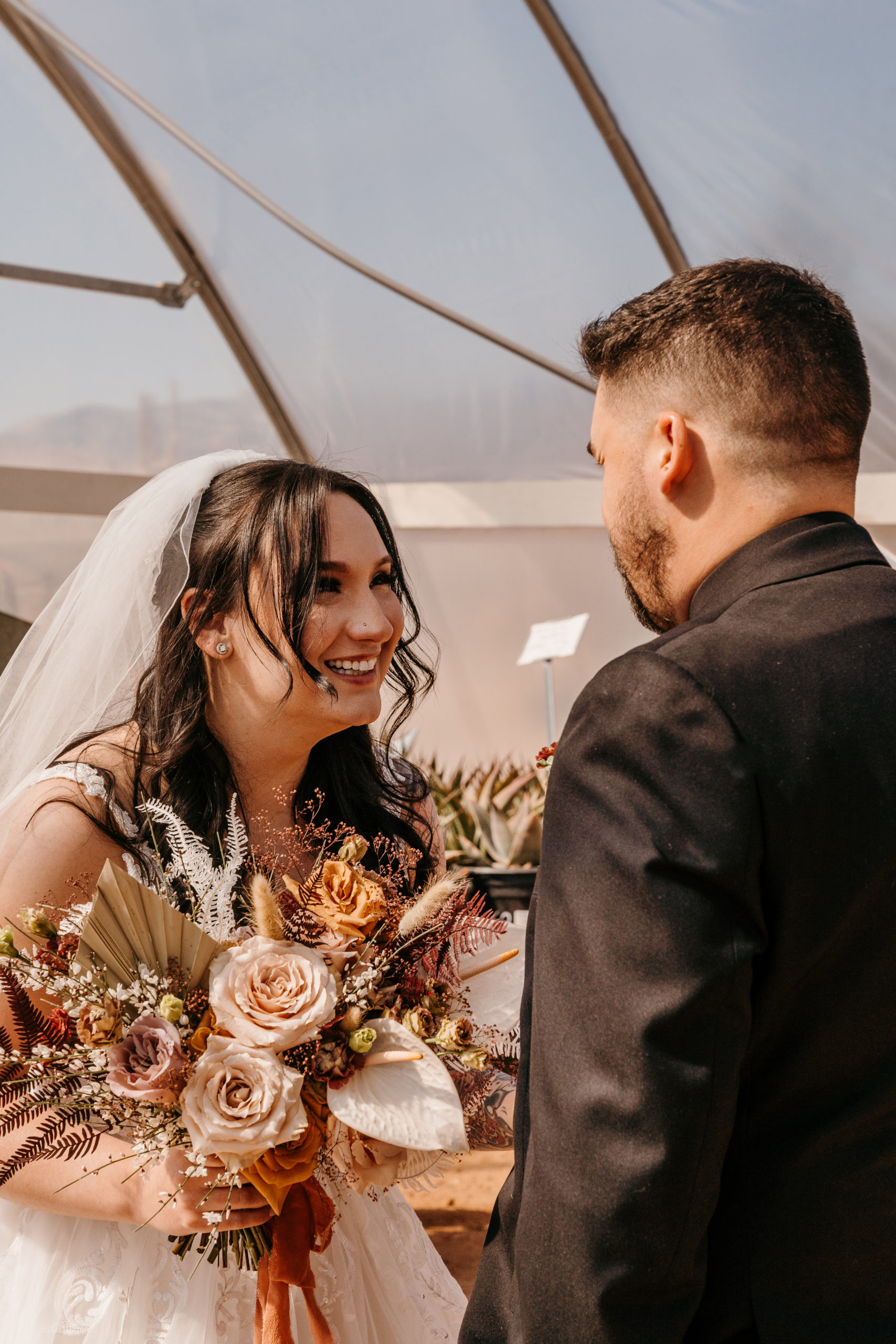 Bride laughing with groom after first look during Modern-Boho Las Vegas Elopement