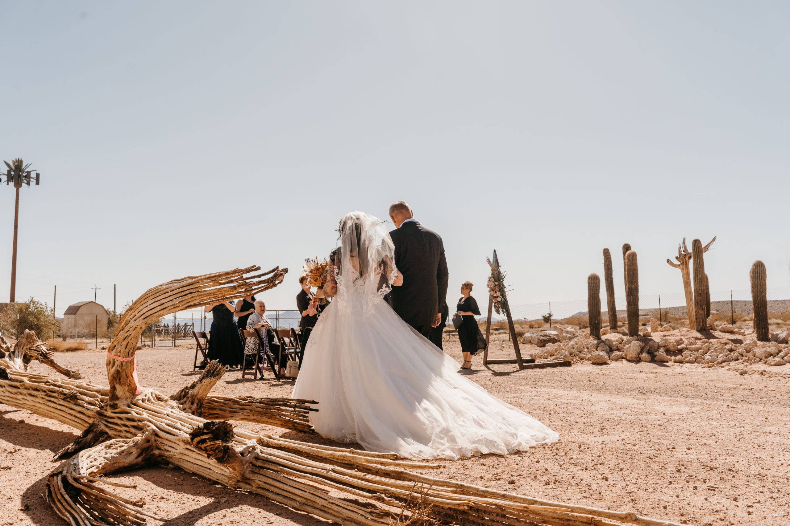 Bride walking to the altar with father in the desert during Modern-Boho Las Vegas Elopement