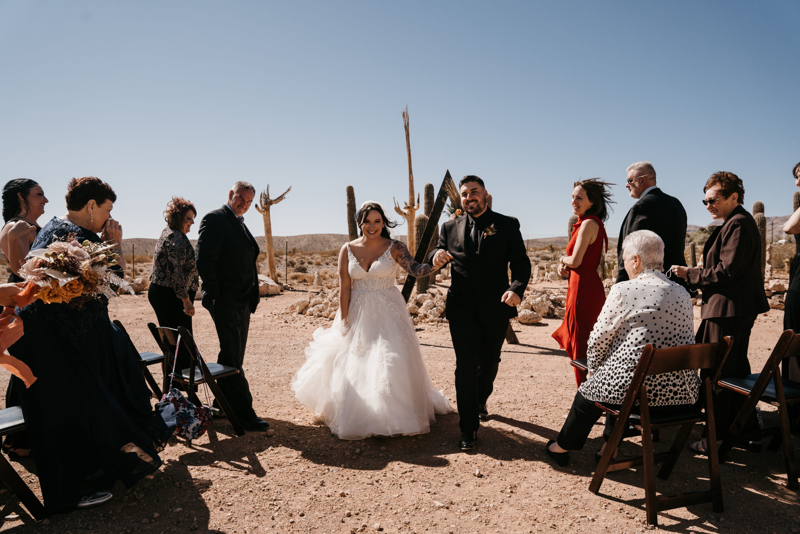 Newlyweds exiting their elopement ceremony in Modern-Boho Las Vegas Elopement