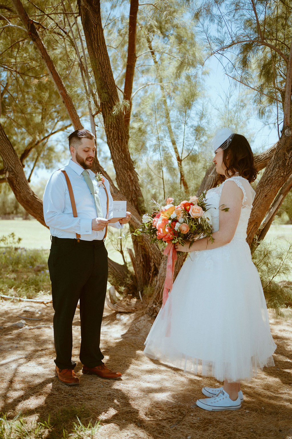 couple reading vows to eachother before ceremony 