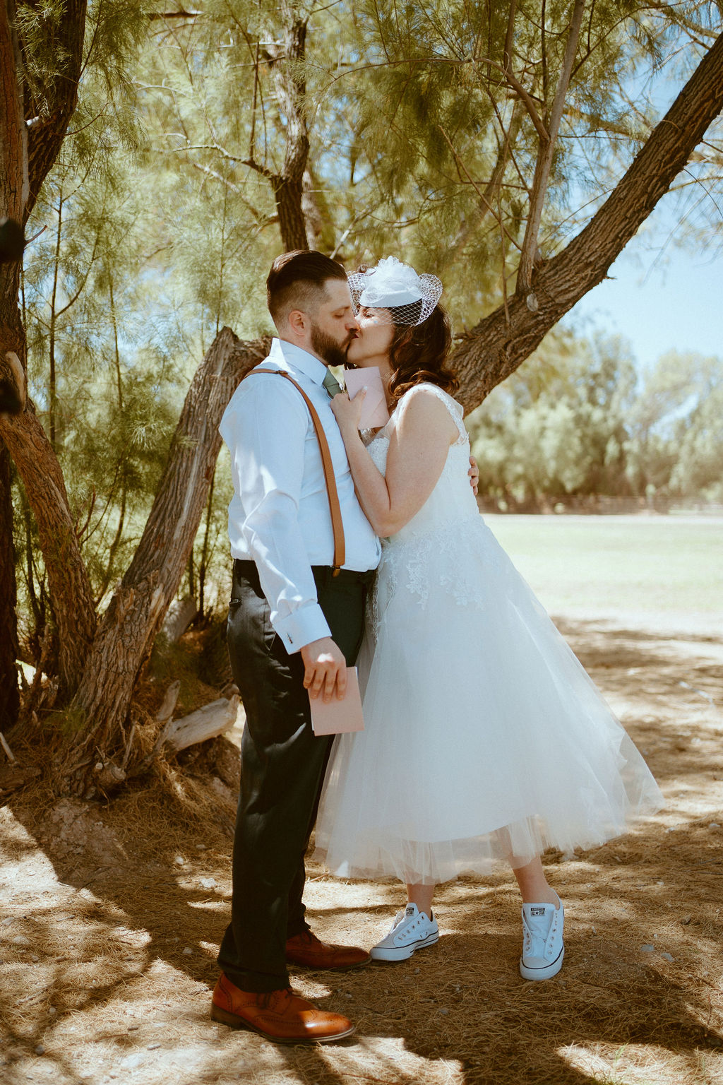 bride and groom kissing during first look in pasture 
