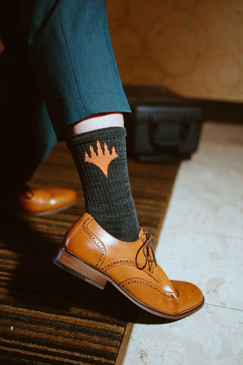 Groom's fancy sock and brown shoes while getting ready for wedding 
