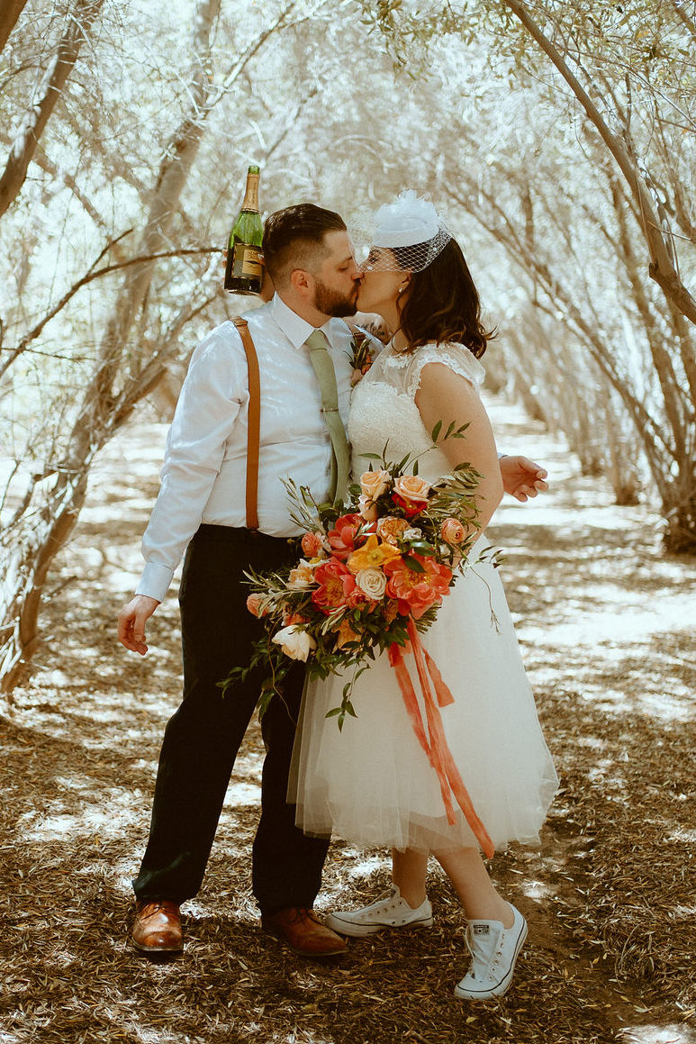 Couple Kissing in Olive Grove for Vintage Elopement 