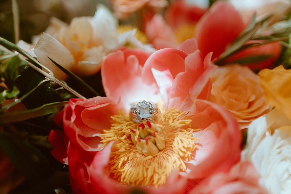 Wedding Ring on Peach and yellow flower in bouquet for Vintage Elopement 
