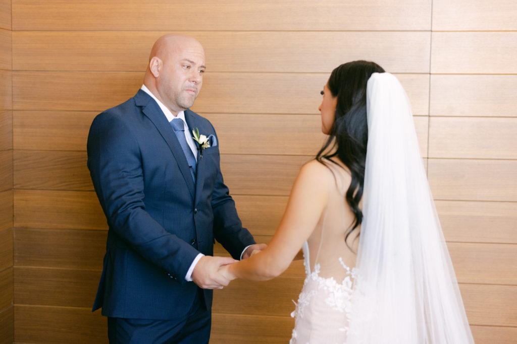 Bride and her dad holding hands after Father Daughter First Look 