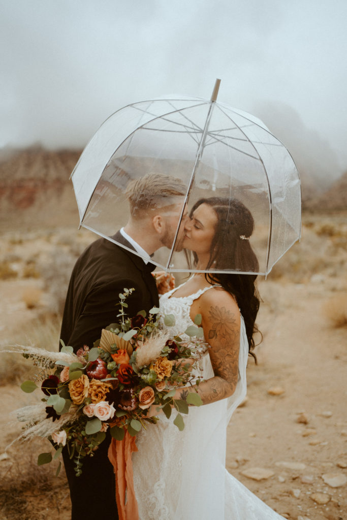 couple kissing under umbrella