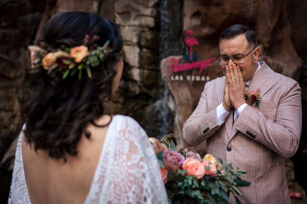 Groom looking at bride for first time during First Look outside of Flamingo Hotel in Las Vegas 