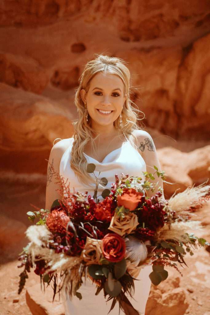 Bride smiling with bohemian bouquet 