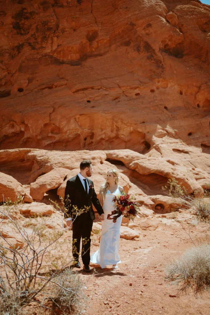 Bride and groom walking toward ceremony location at Valley of Fire 