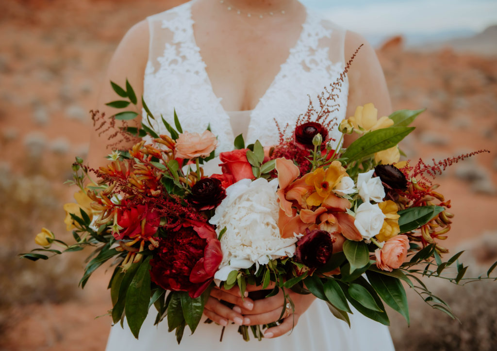 Brides over sized Fall themed desert bridal bouquet with mustard and terracotta florals 