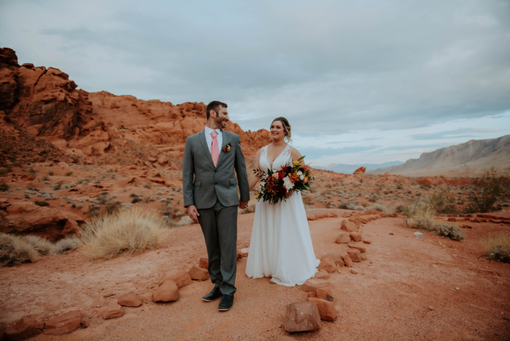 Couple adventuring after fall themed bohemian wedding 