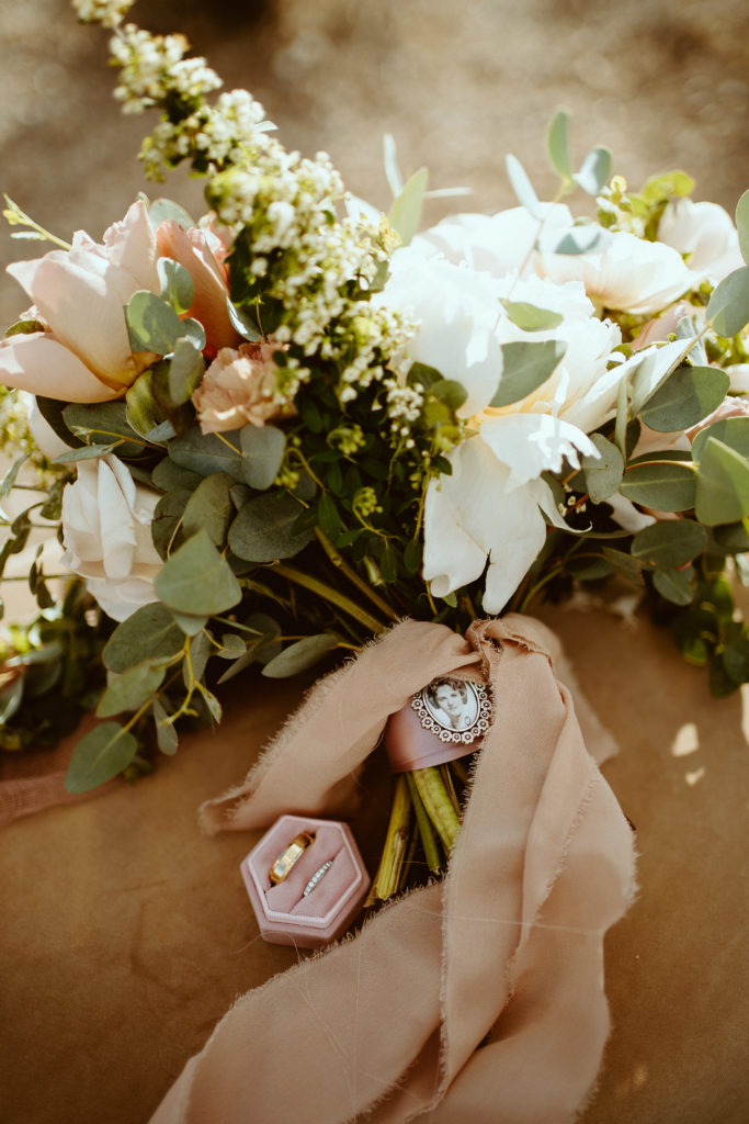 bride remembering loved one with locket on her bouquet  