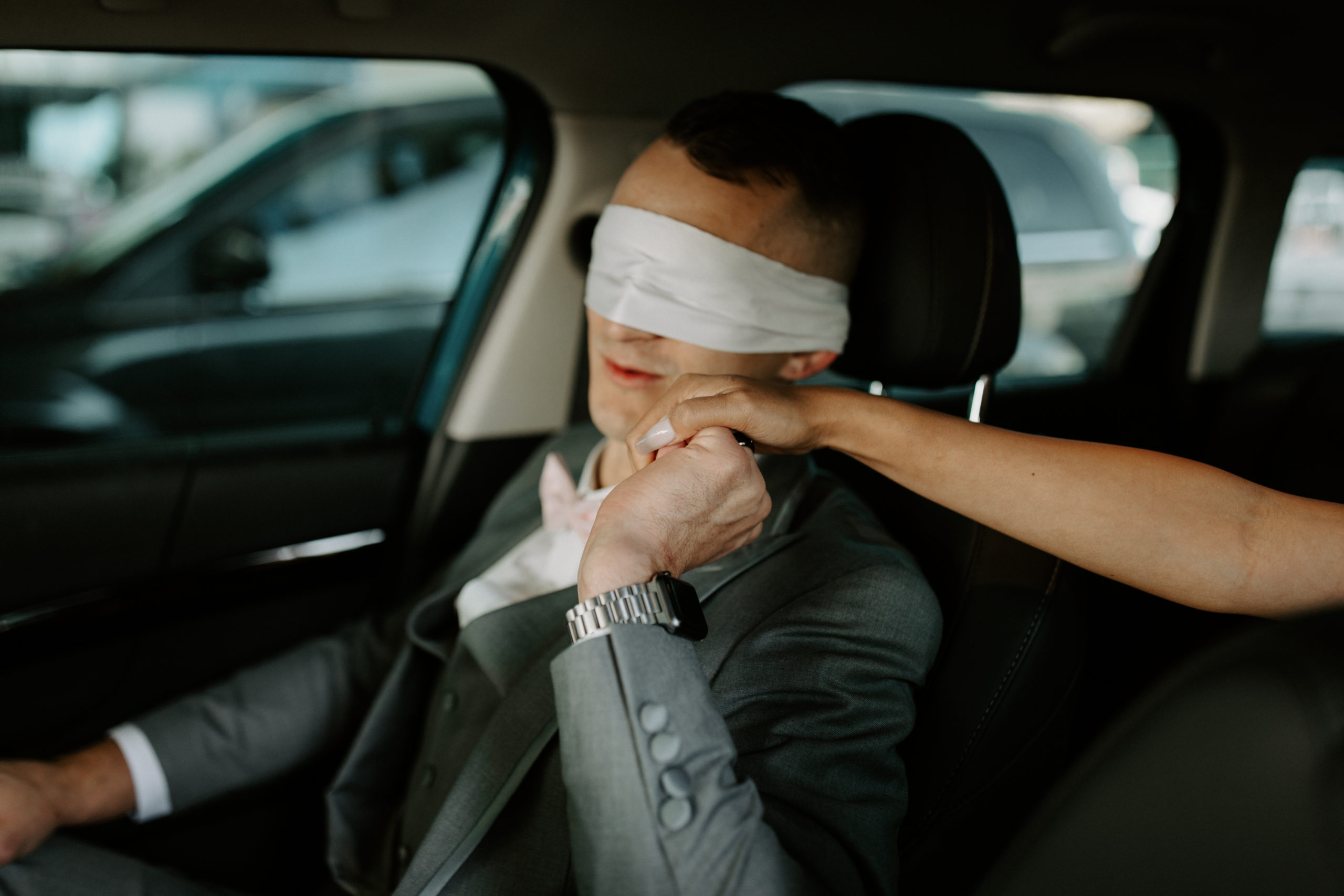 Groom kissing brides hand while blindfolded before first look 