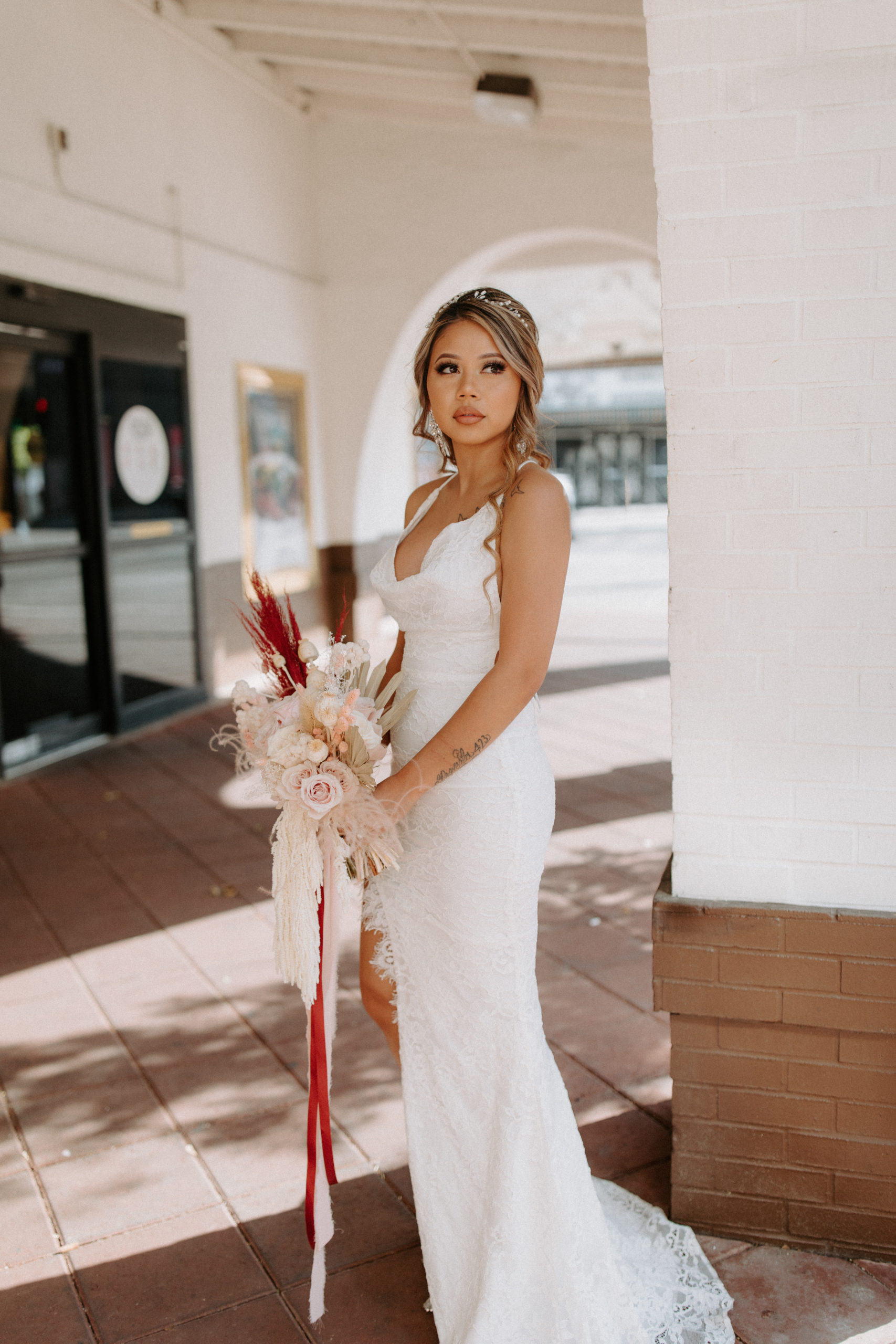 Bride in lace dress with monochromatic bouquet 