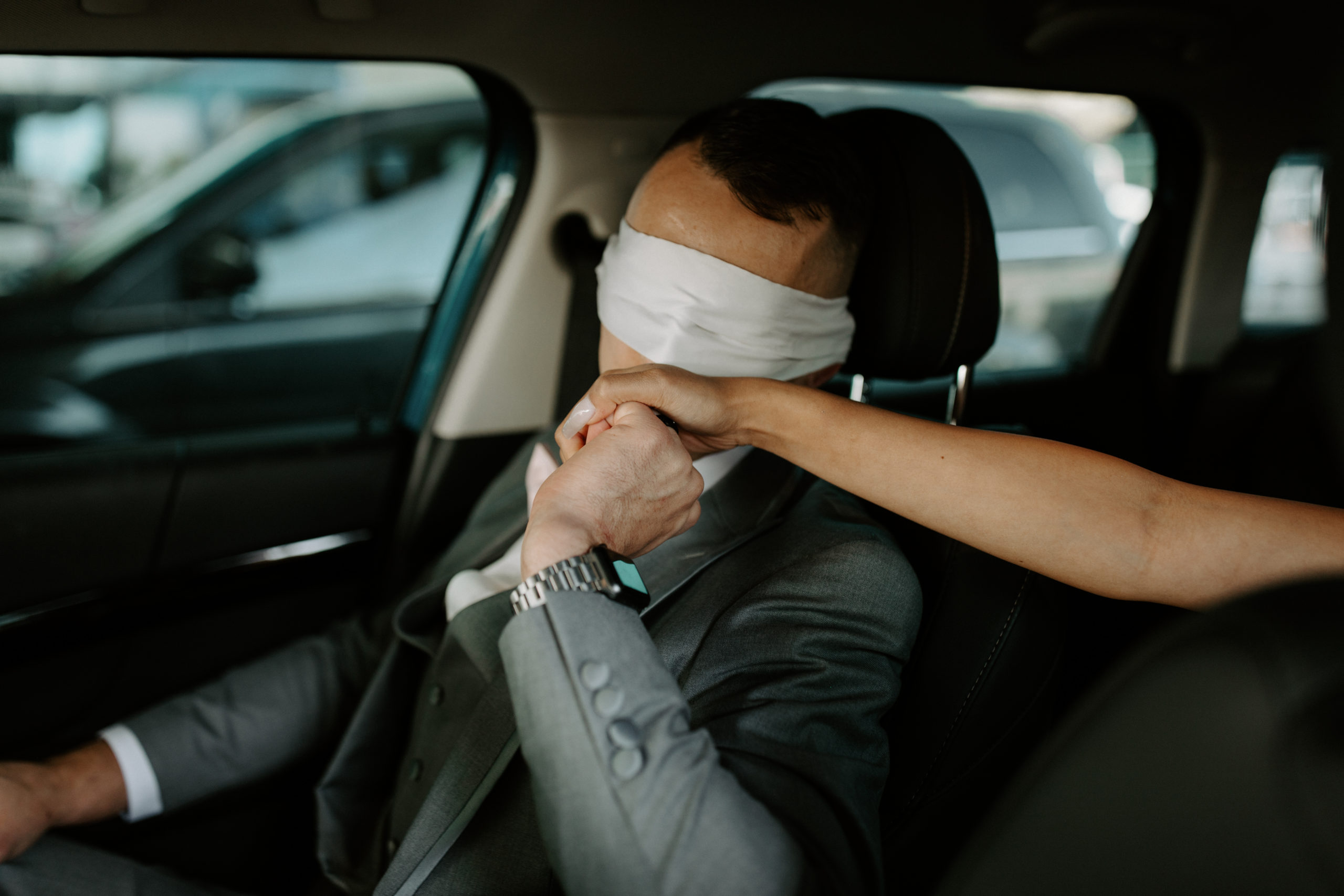 Groom kissing brides hand while blindfolded before first look in downtown Las Vegas 