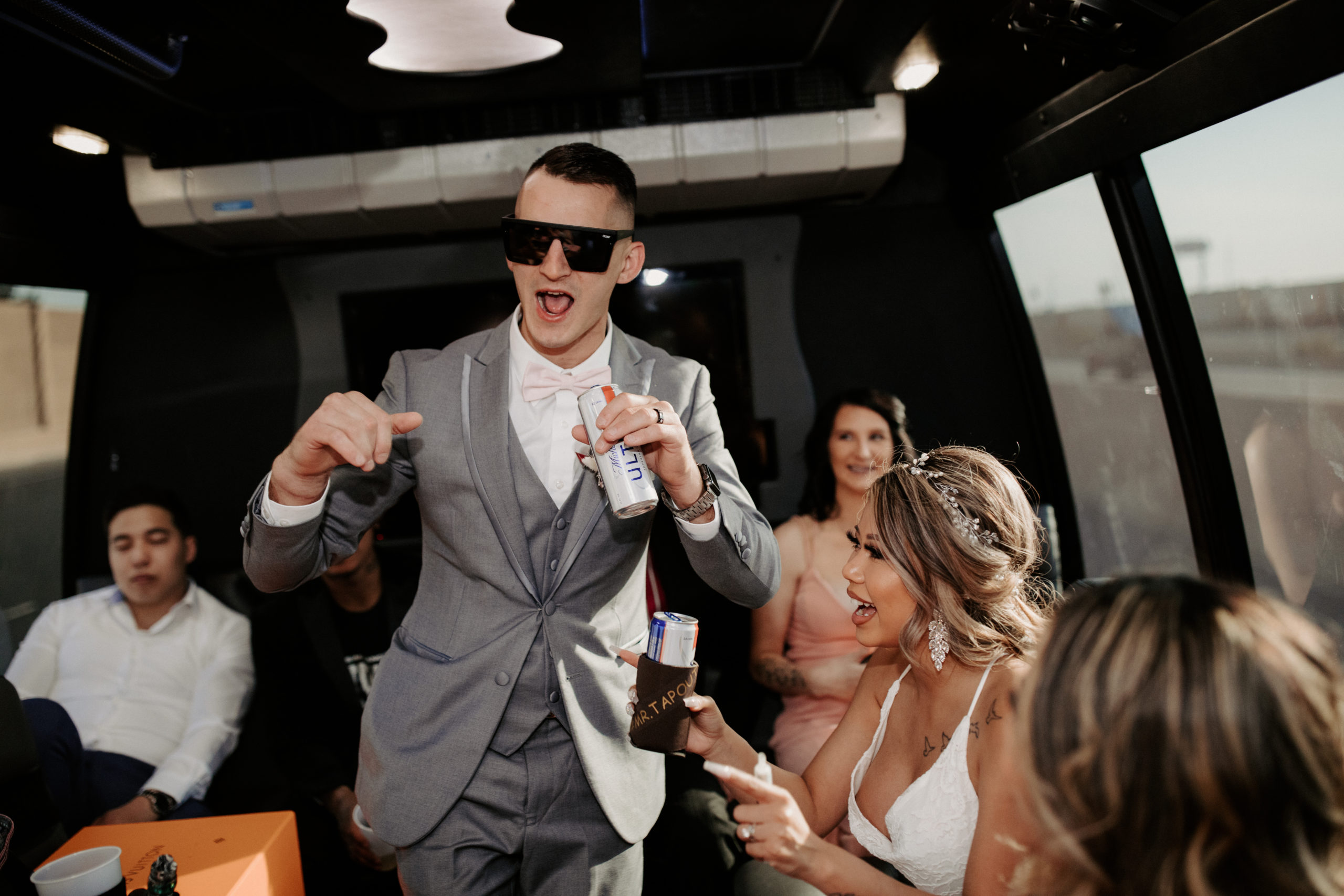 Couple & guests having a good time on party bus on their way to elopement location