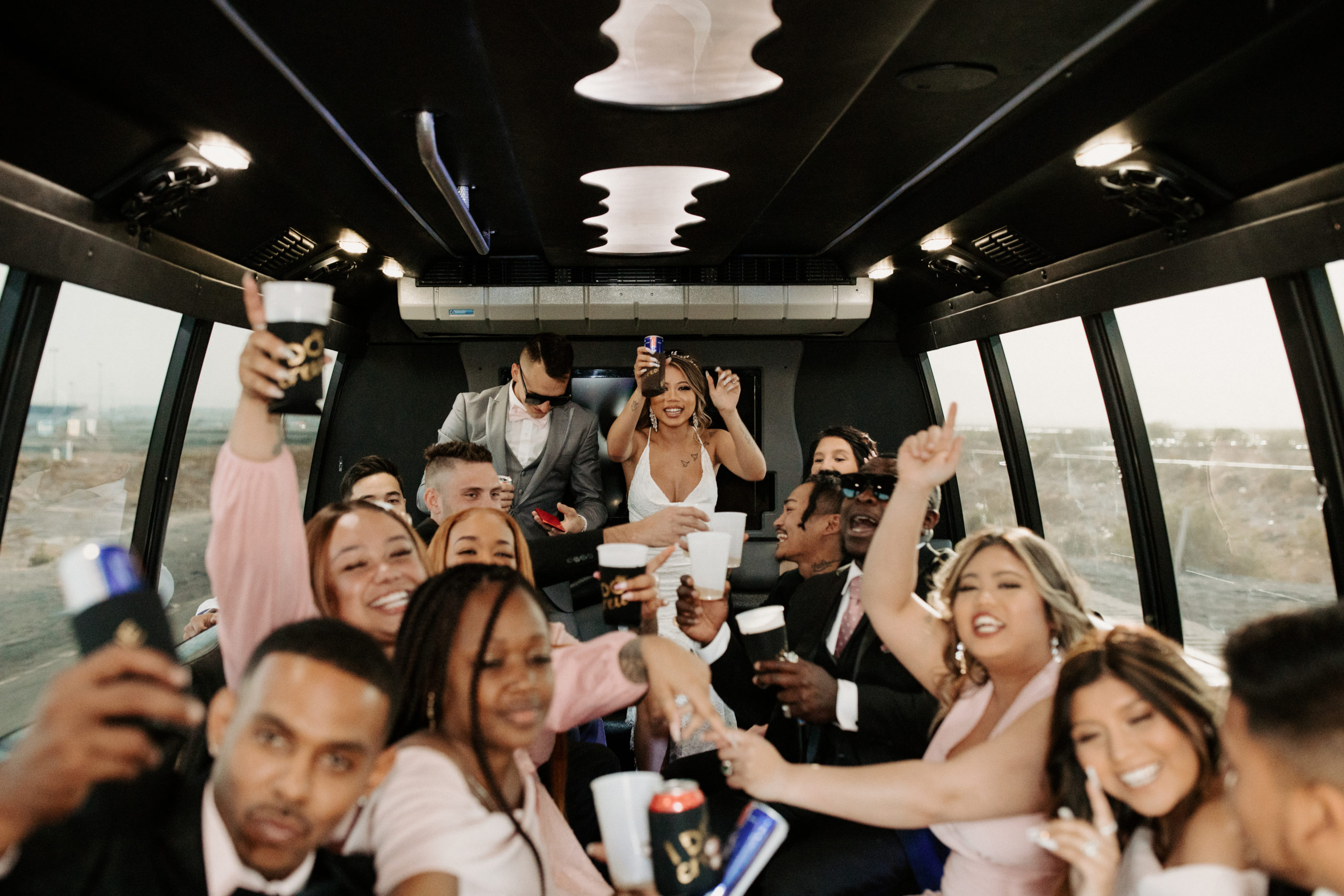 Bride and Groom in Party Bus with Guests 