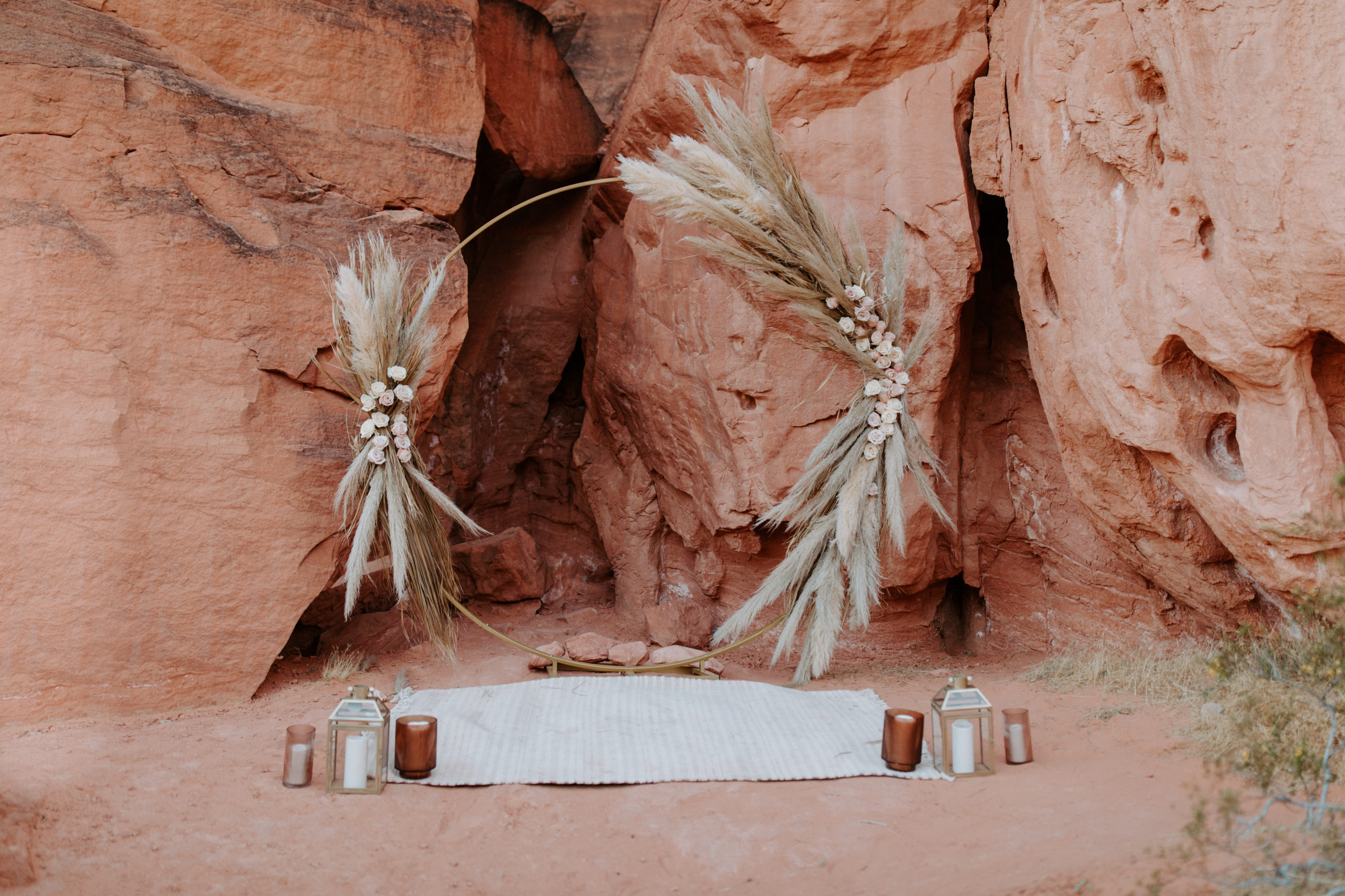 Circle Arch Ceremony-Set-up with Rug, Candles, and Lantern for Boho Pampas Desert Elopement