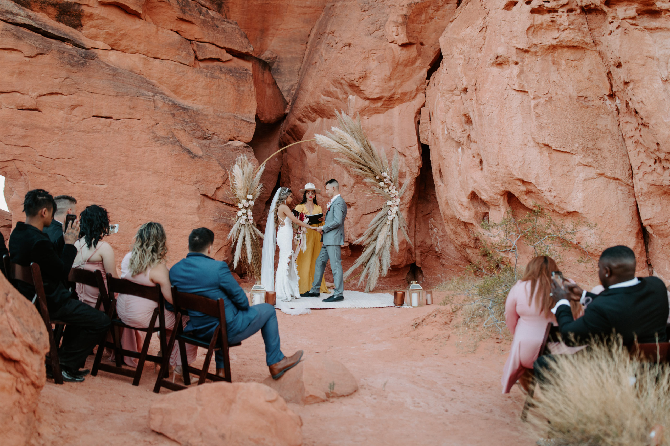 Bride and Groom eloping under Circle Arch with dramatic Pampas