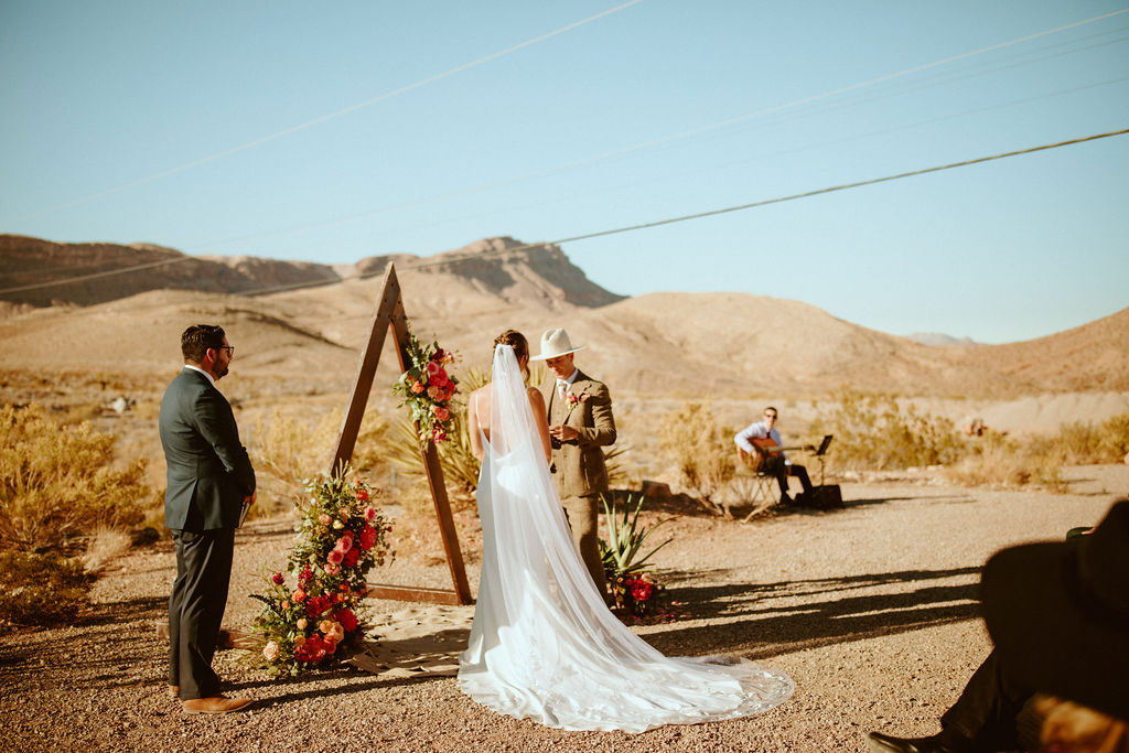 Groom reading vows to bride in Cactus Joe's Wedding 
