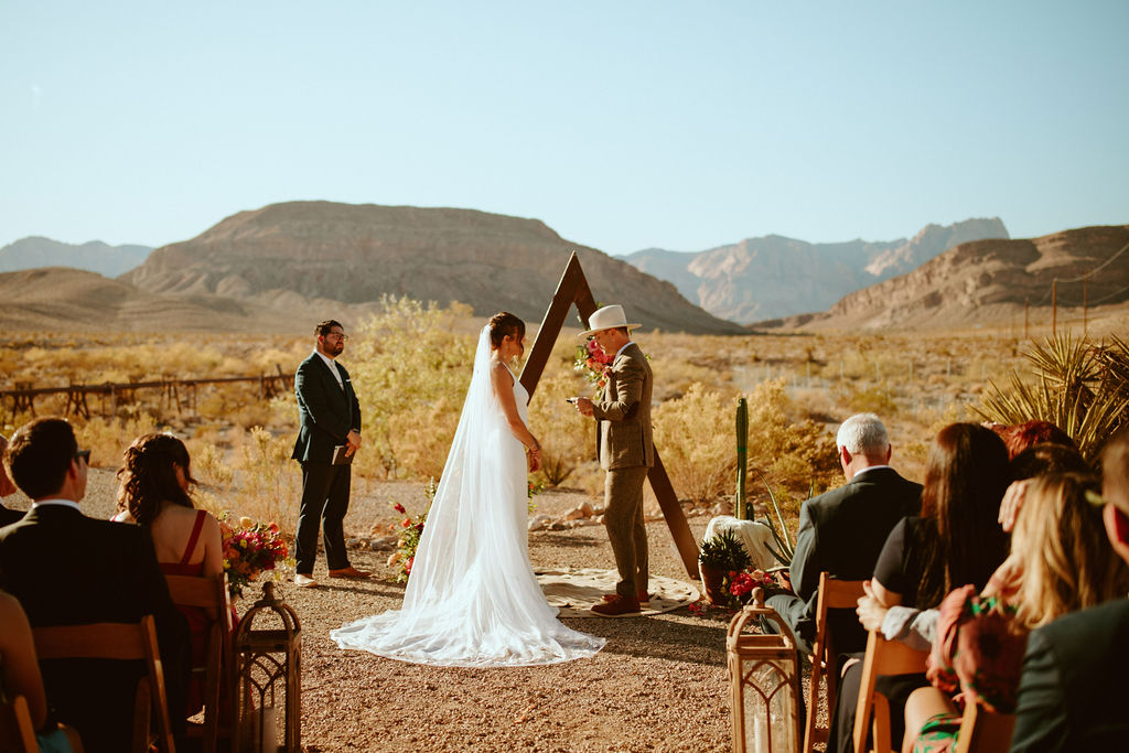 Groom Reading Personal Vows during Desert Wedding 