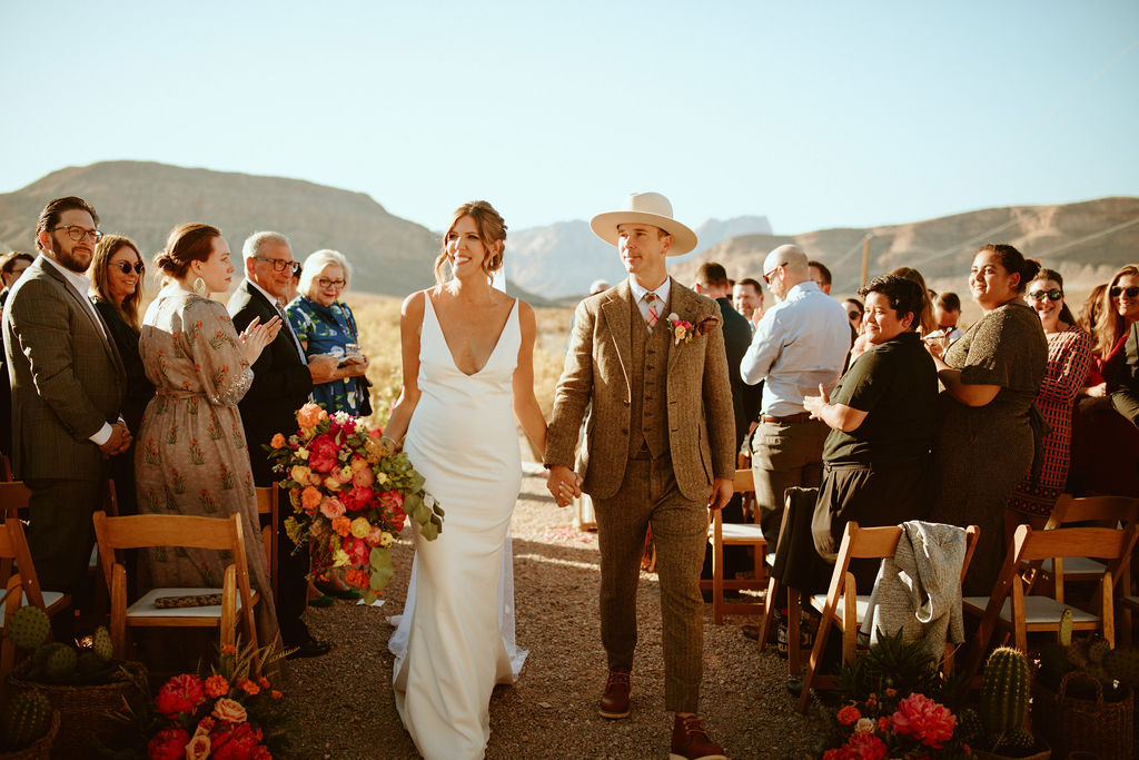 Newlyweds after Bright & Bold Sunset Desert Wedding Ceremony in Cactus Nursery 