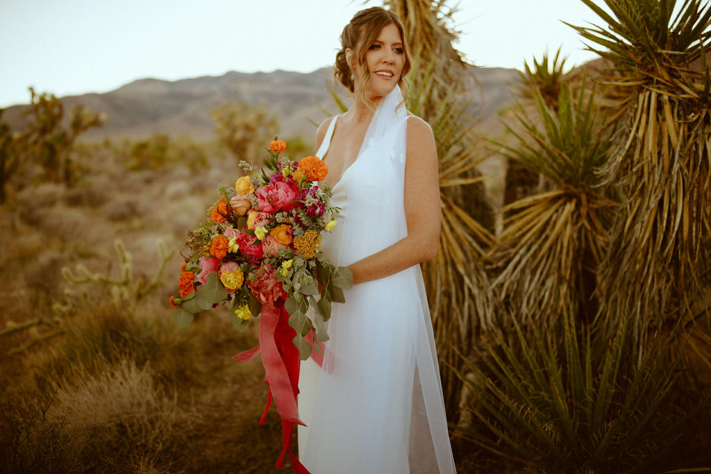 Bride holding bright and colorful bouquet 