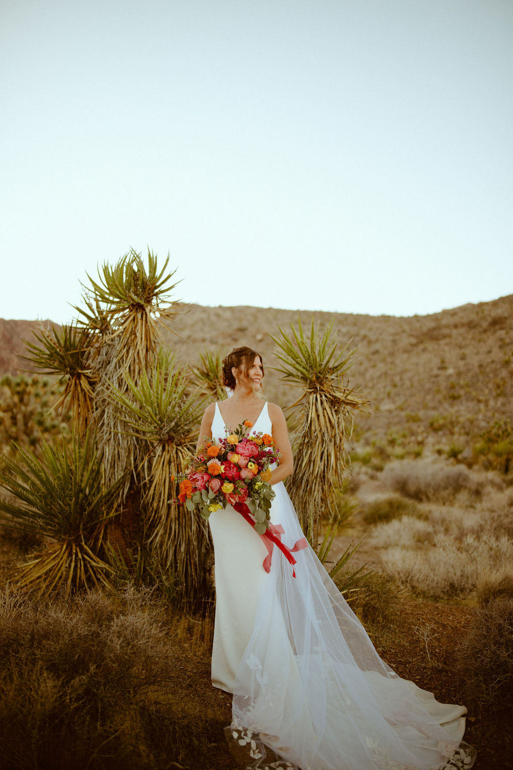 Bride in Desert with Pink, Orange and Mustard Bouquet after Cactus Nursery Wedding Ceremony 