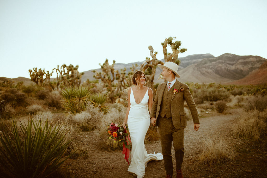 Bright & Bold Sunset Desert Wedding Newlyweds with Mountains and Cactus in the Background 