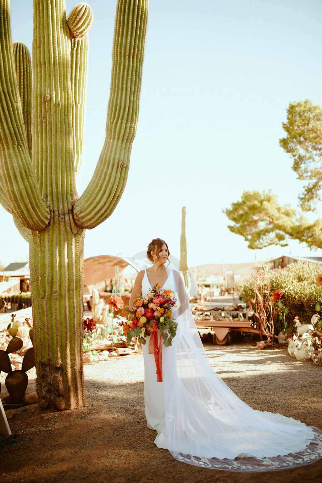 Bride with Bright & Bold Bouquet Standing next to Giant Cactus at Cactus Joe's Nursery. 