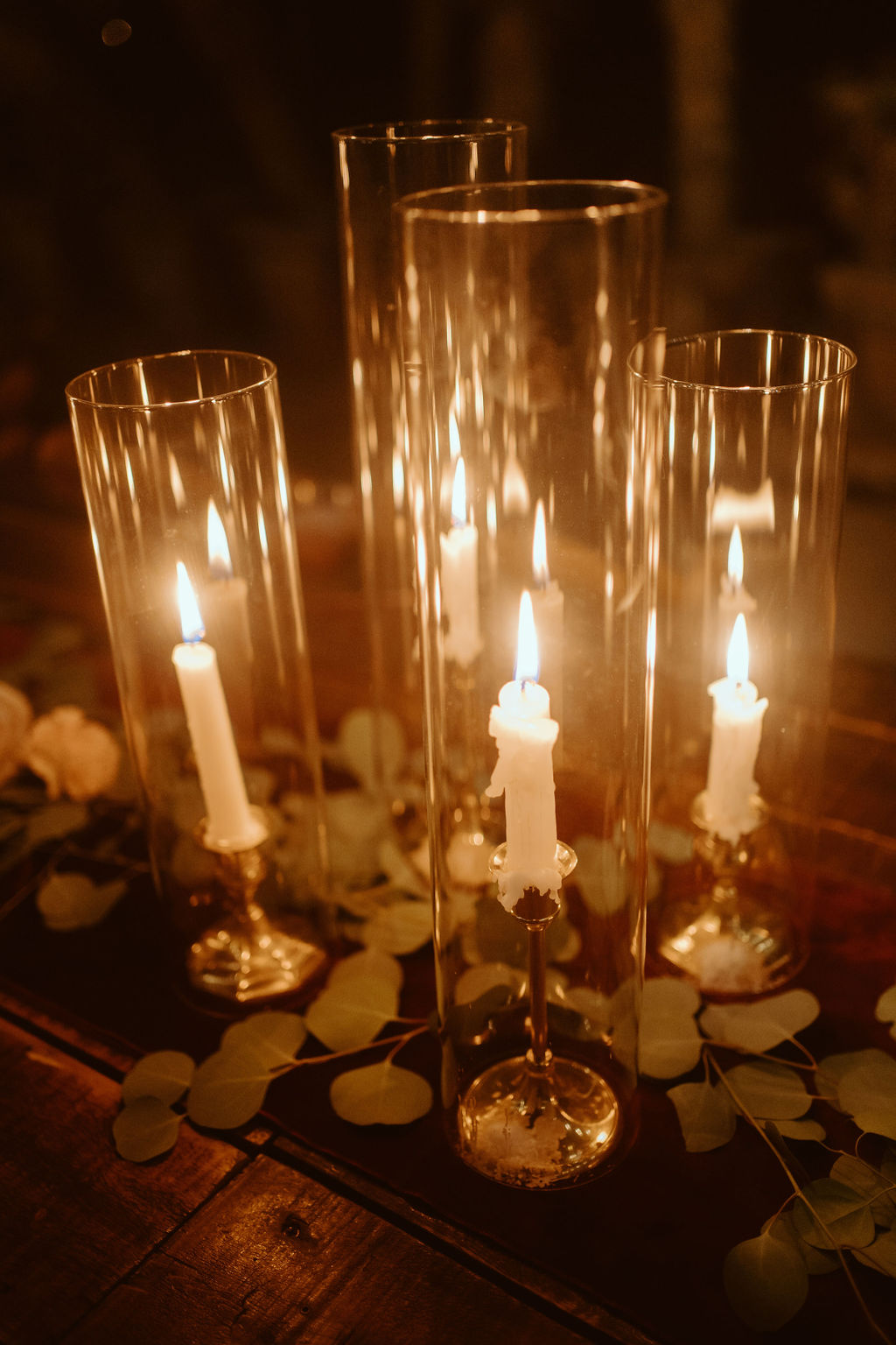 Candles Melting in Hurricane Glass for Outdoor Wedding Reception  