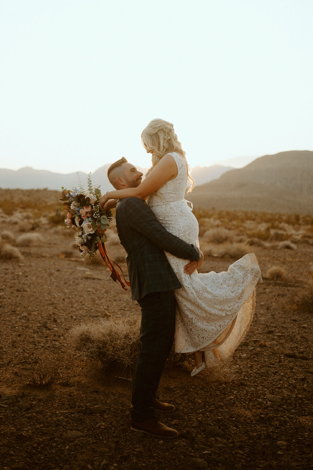 Groom Picking Bride up in Desert 