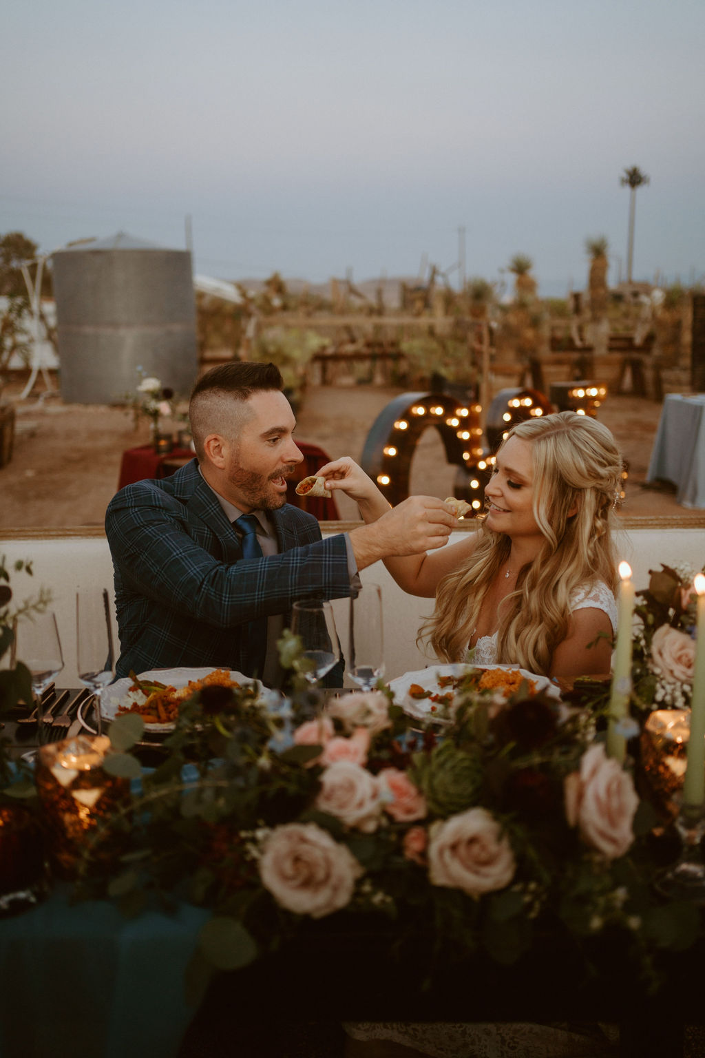 Bride and Groom Feeing Each other Tacos and Micro-Wedding in Las Vegas during Outdoor Wedding Reception 