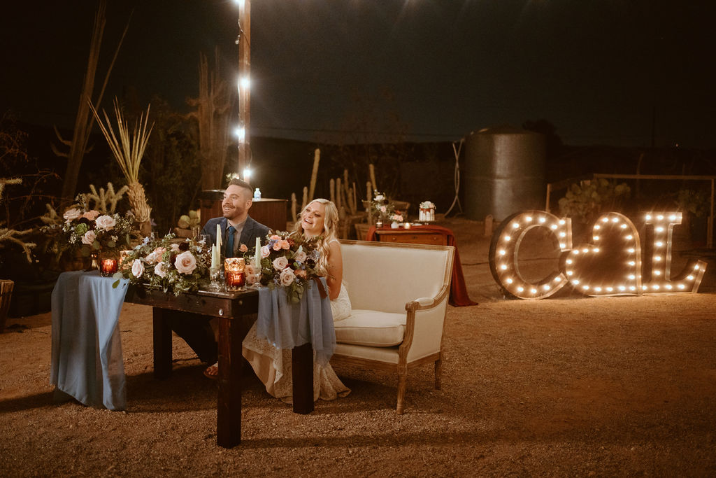 Couple at Sweetheart Table with Custom Marquee Letters 